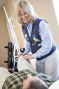 PT helping patient during session