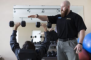 Physical therapist training expert Lucas demonstrates safe lifting to provide recovery from surgery and sports injury rehabilitation in Cody Wyoming